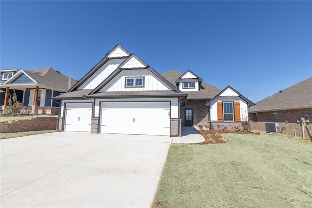 view of front facade featuring an attached garage, cooling unit, brick siding, concrete driveway, and board and batten siding