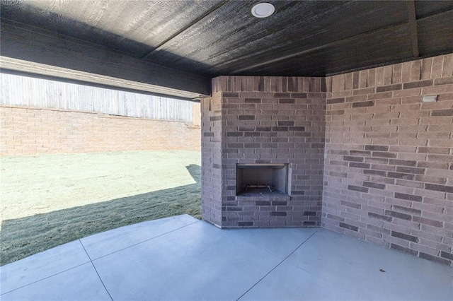 view of patio with an outdoor brick fireplace