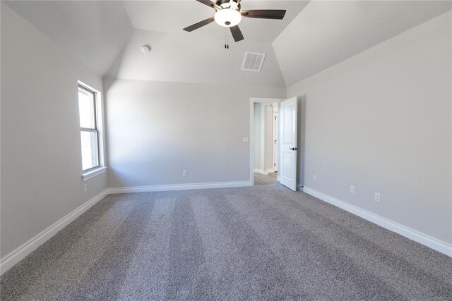 unfurnished room featuring lofted ceiling, carpet floors, baseboards, and visible vents