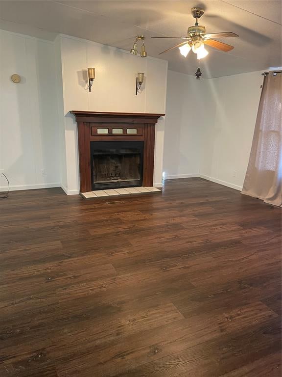 unfurnished living room featuring dark hardwood / wood-style floors and ceiling fan