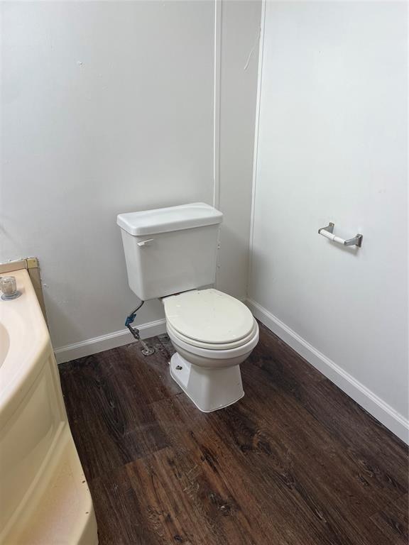 bathroom featuring hardwood / wood-style floors, vanity, and toilet