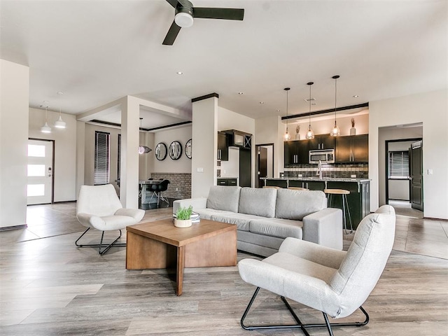 living room with ceiling fan and light hardwood / wood-style floors