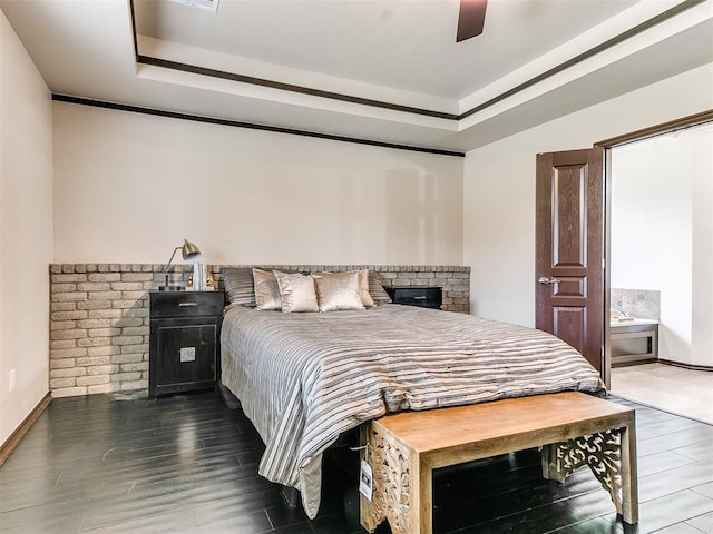 bedroom featuring a tray ceiling, ceiling fan, and dark hardwood / wood-style flooring