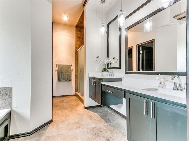 bathroom featuring vanity and a shower with door