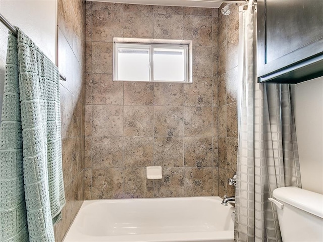 bathroom with shower / bath combo with shower curtain and toilet