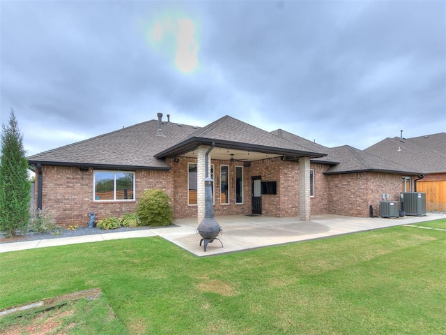 back of house with a patio, central air condition unit, ceiling fan, and a lawn