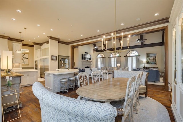 dining space featuring crown molding, ceiling fan, and dark wood-type flooring