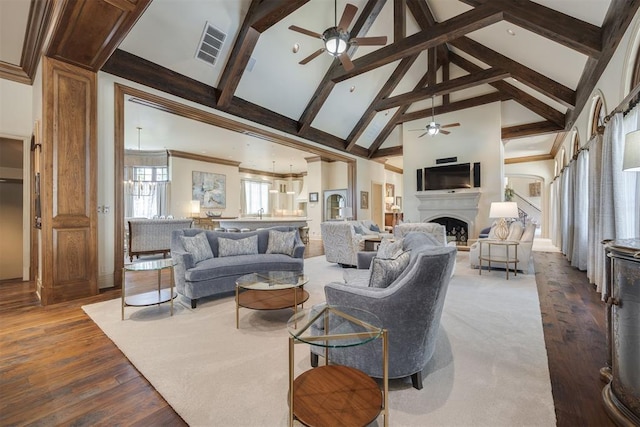 living room featuring wood-type flooring, high vaulted ceiling, ceiling fan, and beam ceiling