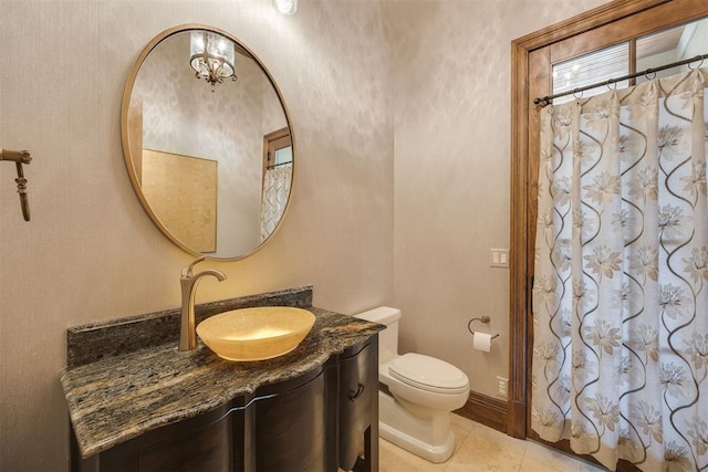 bathroom featuring tile patterned flooring, vanity, and toilet