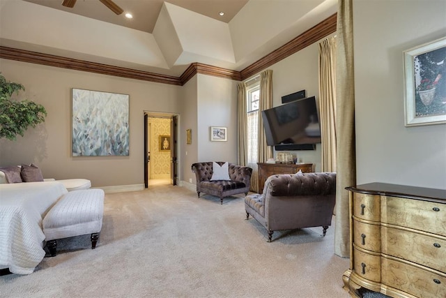 carpeted bedroom with ensuite bathroom, a raised ceiling, and ornamental molding