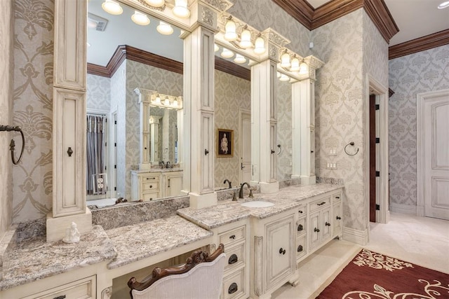 bathroom featuring vanity, ornate columns, and crown molding