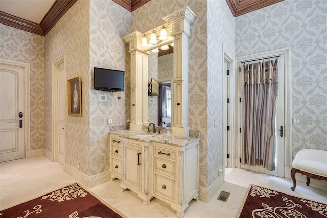 bathroom featuring crown molding, tile patterned flooring, and vanity