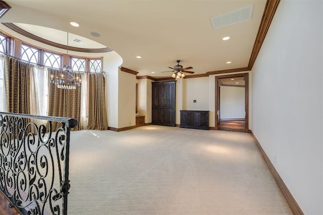 corridor with light colored carpet, crown molding, and an inviting chandelier