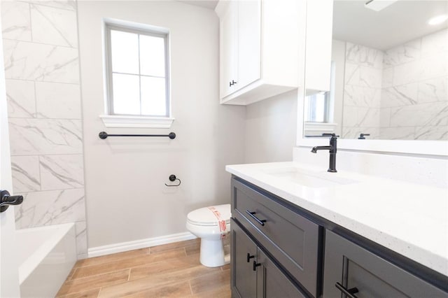 full bath with tub / shower combination, vanity, toilet, wood tiled floor, and baseboards