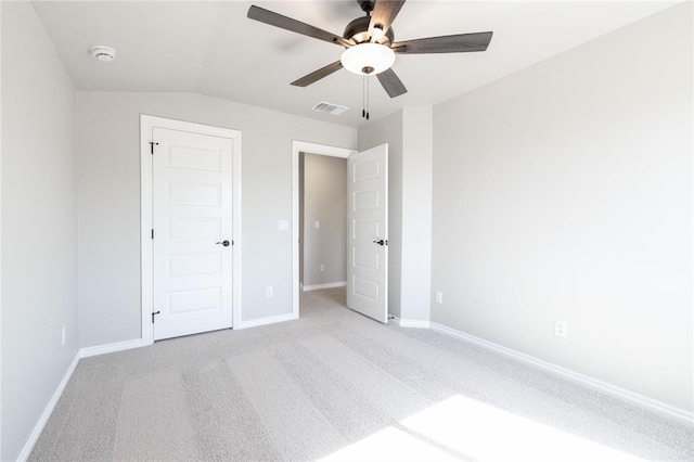 unfurnished bedroom featuring light carpet, visible vents, baseboards, and ceiling fan
