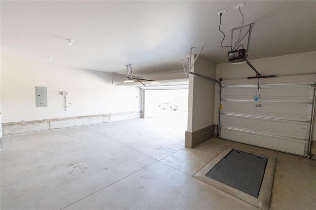 garage featuring electric panel and a garage door opener