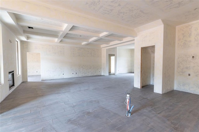 empty room with beamed ceiling and coffered ceiling