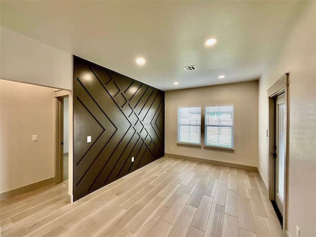 empty room with light hardwood / wood-style floors