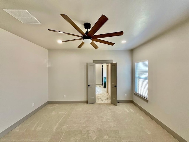 unfurnished room featuring light carpet and ceiling fan