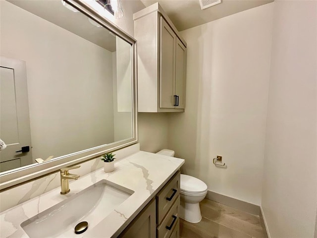 bathroom with wood-type flooring, vanity, and toilet