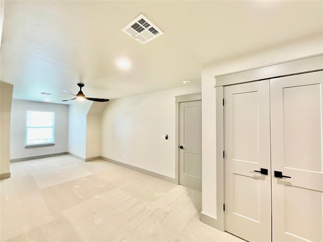 interior space featuring ceiling fan and light carpet