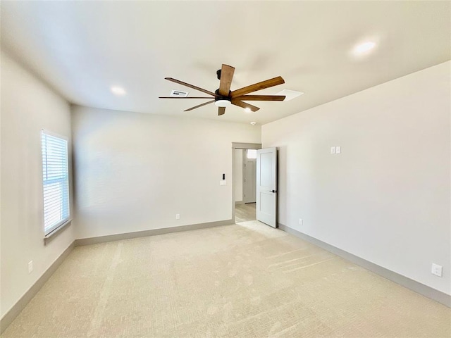 carpeted spare room with ceiling fan