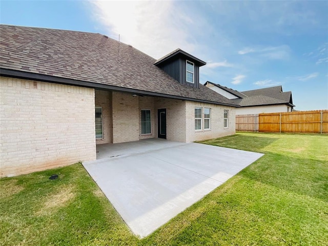 back of house featuring a yard and a patio