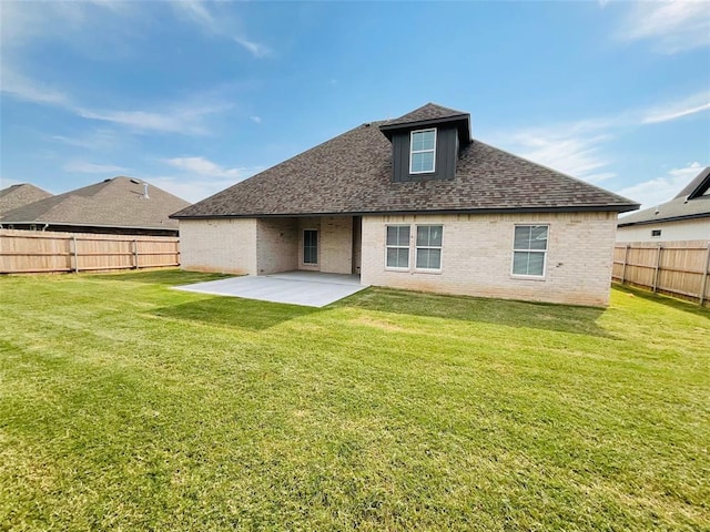 rear view of property featuring a yard and a patio