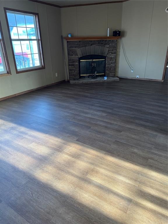 unfurnished living room with a stone fireplace and wood-type flooring