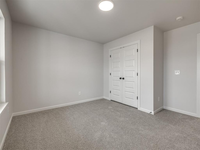 unfurnished bedroom with a closet and carpet