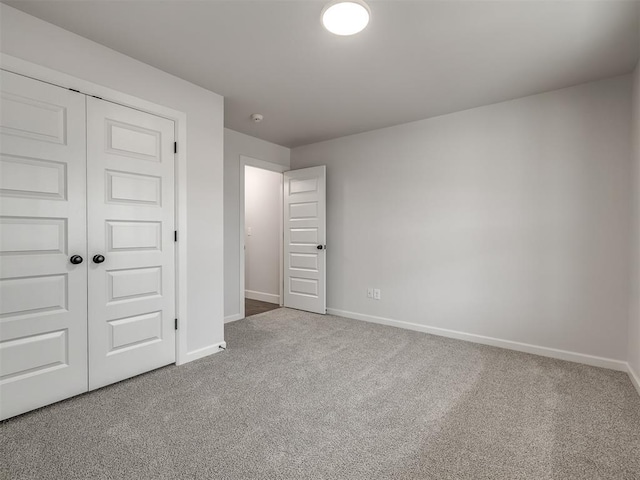 unfurnished bedroom featuring carpet floors and a closet