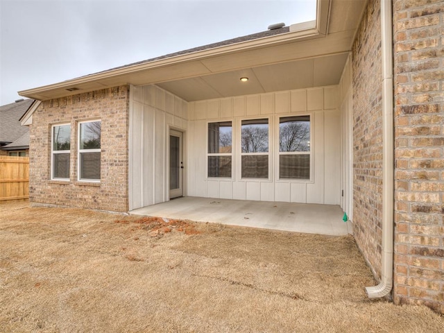 entrance to property featuring a patio