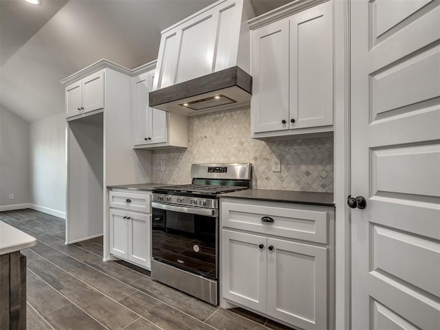 kitchen with backsplash, gas range, custom range hood, and white cabinets