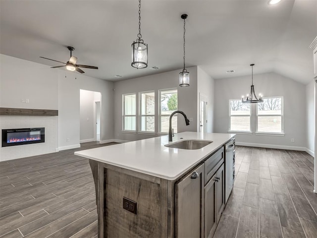 kitchen with stainless steel dishwasher, sink, a center island with sink, and a wealth of natural light