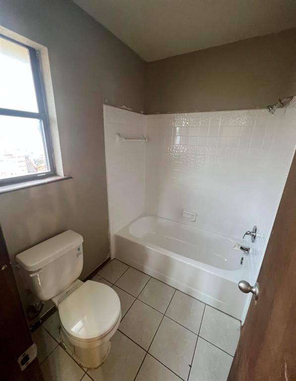 bathroom with shower / washtub combination, tile patterned flooring, and toilet