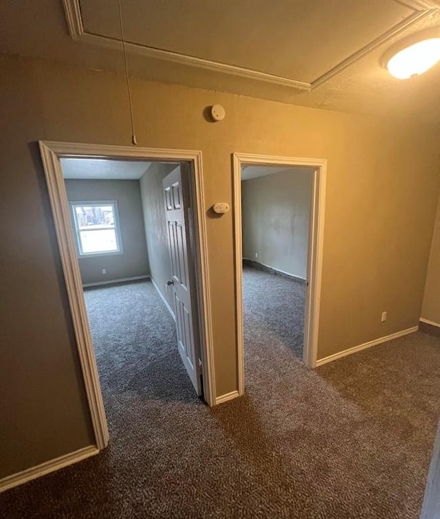 hallway with dark colored carpet