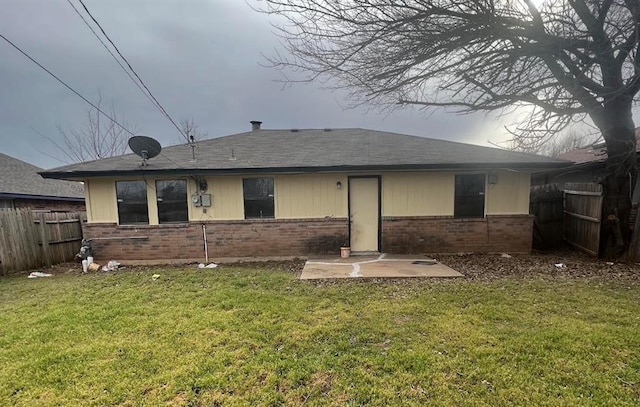 back of property featuring a patio area and a yard