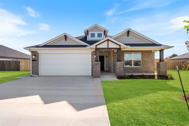 craftsman inspired home with a garage and a front lawn