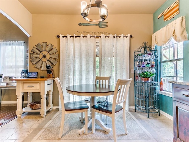 3393 Creek View Ct, Newcastle, OK 73065 - dining space with a chandelier, baseboards, and stone tile floors