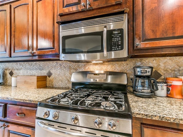 3393 Creek View Ct, Newcastle, OK 73065 - kitchen featuring stainless steel appliances, tasteful backsplash, and light stone countertops