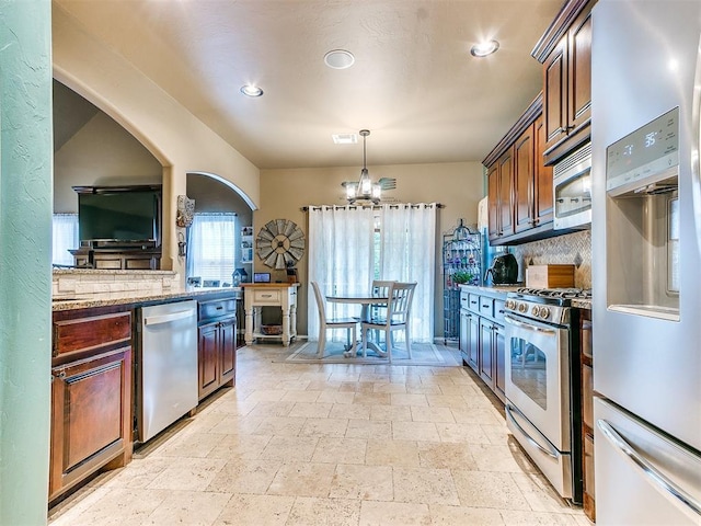 3393 Creek View Ct, Newcastle, OK 73065 - kitchen featuring appliances with stainless steel finishes, stone tile floors, a chandelier, decorative backsplash, and recessed lighting