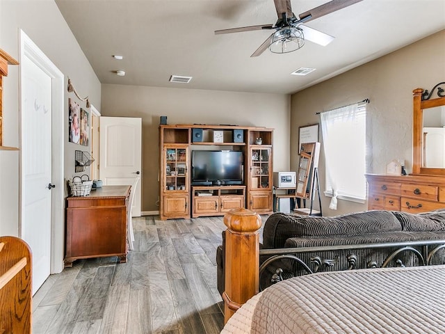 bedroom with ceiling fan and light hardwood / wood-style flooring