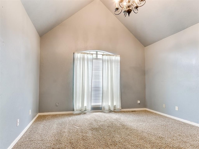 carpeted spare room with high vaulted ceiling and an inviting chandelier