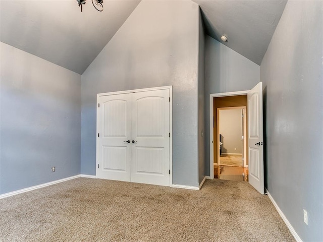 unfurnished bedroom with lofted ceiling and light carpet