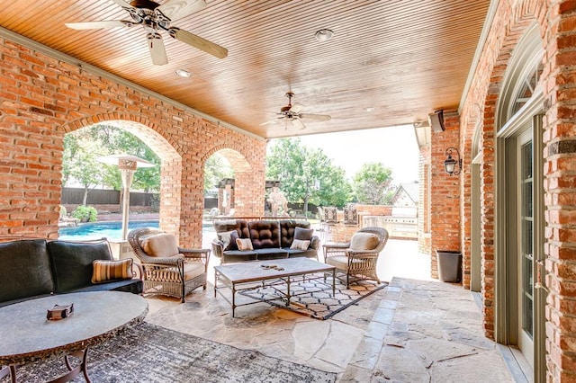 view of patio / terrace featuring a fenced in pool, outdoor lounge area, and ceiling fan