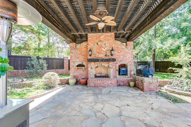 view of patio with an outdoor brick fireplace, a grill, and ceiling fan