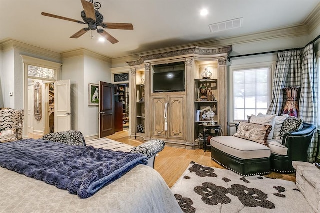 bedroom featuring ornamental molding, ceiling fan, and light hardwood / wood-style flooring