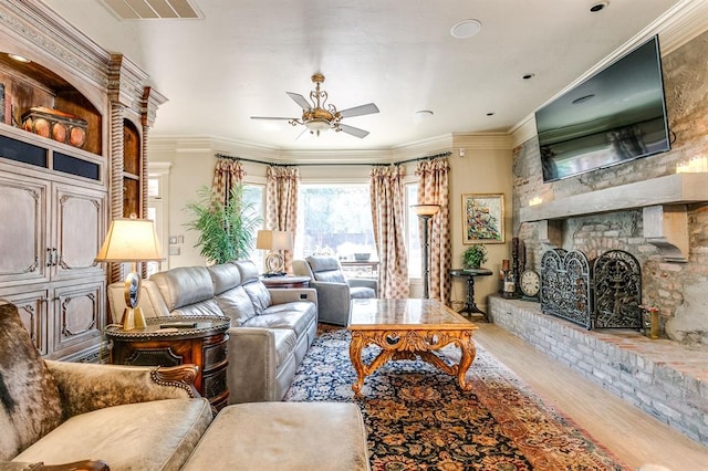 living room featuring hardwood / wood-style flooring, ceiling fan, and ornamental molding