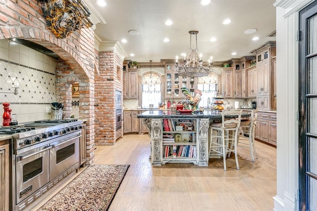 kitchen with appliances with stainless steel finishes, decorative light fixtures, a breakfast bar area, a center island, and crown molding