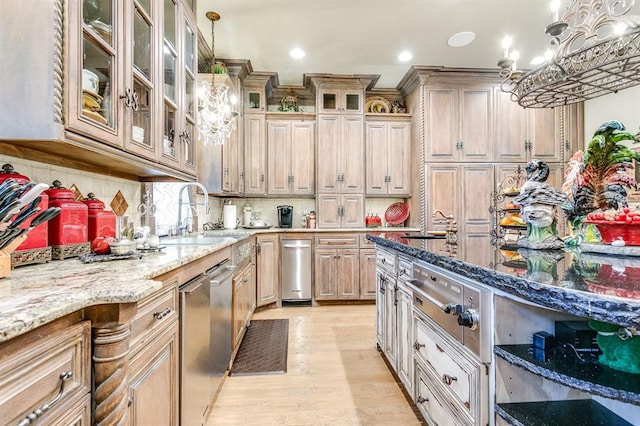 kitchen with sink, tasteful backsplash, hanging light fixtures, light wood-type flooring, and light stone countertops